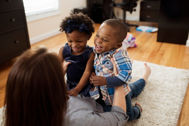 Childminder playing with two children